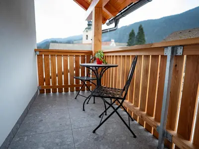 a table and two chairs on a balcony at Pr Štepiherju in Luče