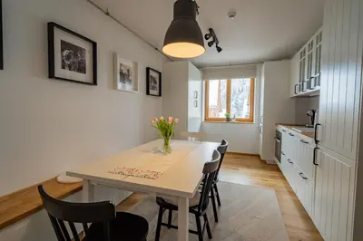 a kitchen and dining room with a table and chairs at Apartment ALPINE IBEX, Nordic House, Kranjska Gora - Center in Kranjska Gora