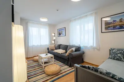 a living room with a couch and a bed at Apartment ALPINE IBEX, Nordic House, Kranjska Gora - Center in Kranjska Gora