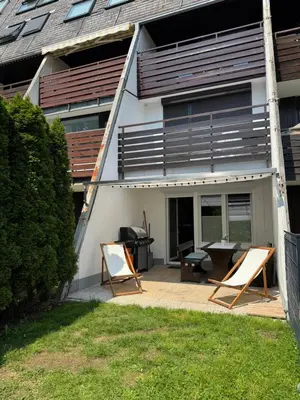 a house with two chairs and a patio at AlpNest with free parking in Bovec