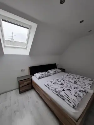 a bedroom with a large bed and a window at Comfortable 4 room 4 full Family in Tržič