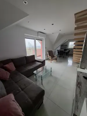 a living room with a couch and a table at Comfortable 4 room 4 full Family in Tržič