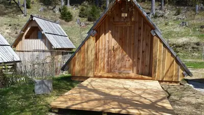 a small wooden building with a door on top at Glamping apartma Oaza miru in Preddvor