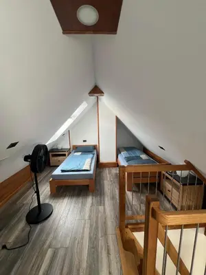 a room with two beds in a attic at APARTMAJI VITEZ Apartma 4 in Bovec