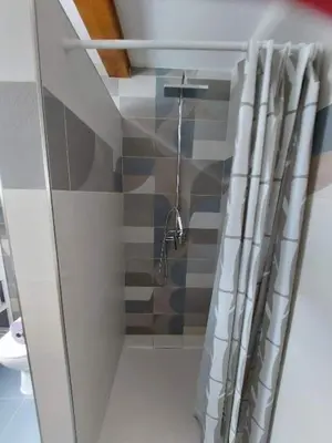 a bathroom with a shower with a shower curtain at APARTMAJI VITEZ Apartma 4 in Bovec
