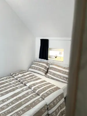 a bedroom with two beds and a window at Apartments Linden Tree in Kamnik