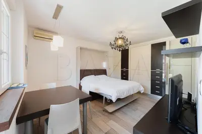 a bedroom with a bed and a desk and a television at Apartma BAZA in Bovec