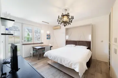 a bedroom with a bed and a desk with a computer at Apartma BAZA in Bovec