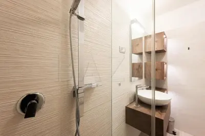 a bathroom with a sink and a glass shower at Apartma BAZA in Bovec