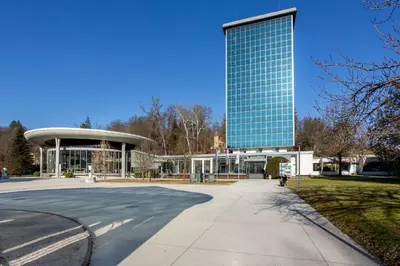 a tall glass building with a road in front of it at Kristal Lux Aparments with a balcony in Rogaška Slatina