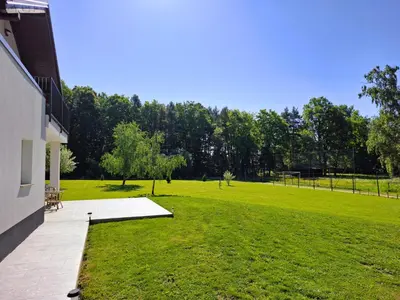 a large grassy yard next to a building at Zelena harmonija in Moravske Toplice