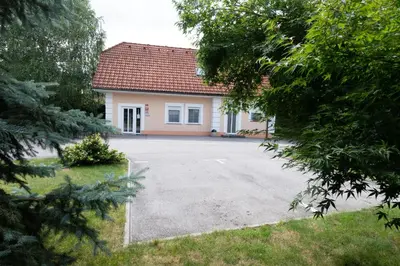 a house with a driveway in front of it at Apartmaji in sobe RaMar in Straža