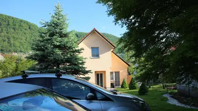 a car parked in front of a house at Apartmaji in sobe RaMar in Straža
