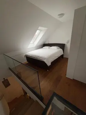 a bedroom with a bed and a glass table at SISSI Apartment Banovci in Veržej