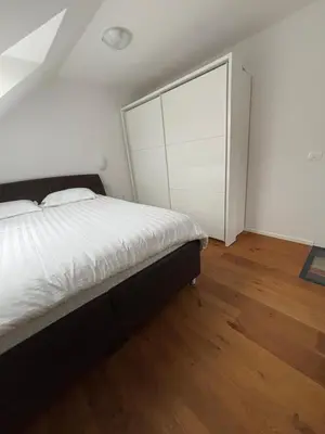 a bedroom with a bed and a large sliding glass door at SISSI Apartment Banovci in Veržej