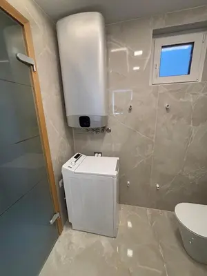 a bathroom with a white toilet and a sink at SISSI Apartment Banovci in Veržej