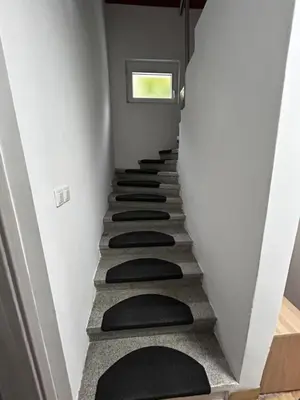a stairway with black cushions on it at Larisa apartma in Domžale
