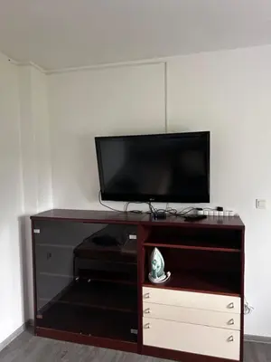 a flat screen tv sitting on top of a entertainment center at Larisa apartma in Domžale