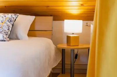 a bedroom with a bed and a table with a lamp at DREAMLAND BLED Apartments in Bled