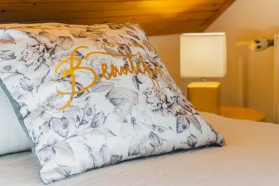 a pillow sitting on top of a bed at DREAMLAND BLED Apartments in Bled