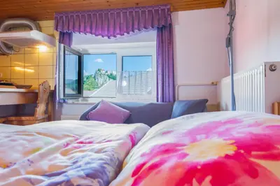 a bedroom with a bed and a window at DREAMLAND BLED Apartments in Bled
