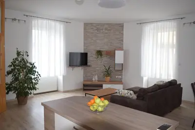 a living room with a couch and a table at Apartma Majerhold in Mozirje