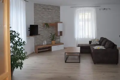 a living room with a couch and a coffee table at Apartma Majerhold in Mozirje