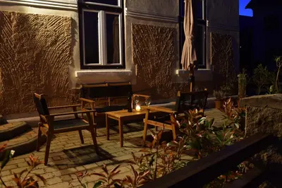 a patio with chairs and a table and an umbrella at Apartma Majerhold in Mozirje