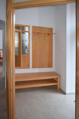 a closet with a wooden bench in a room at Apartma Majerhold in Mozirje