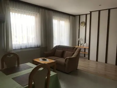 a living room with a couch and a table at Apartments Janjusevic in Bled