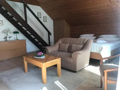a living room with a couch and a bed at Apartments Janjusevic in Bled