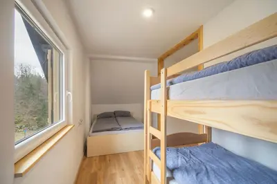 a bedroom with bunk beds in a tiny house at Chalet Fridrihštajn in Kočevje