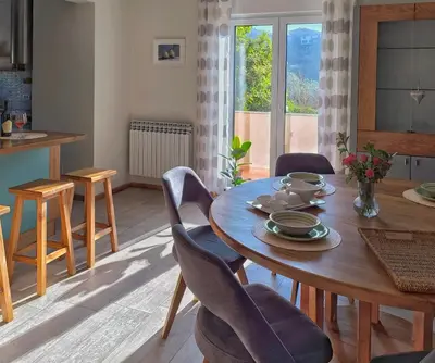 a dining room with a wooden table and chairs at Apartma Sunside in Branik
