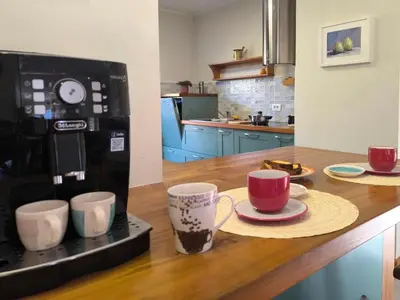 a kitchen with a counter with two coffee cups on it at Apartma Sunside in Branik
