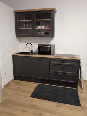 a kitchen with a counter top with a microwave at Urko Apartments Ljubljana in Ljubljana