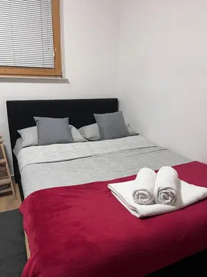 a bedroom with a large bed with towels on it at Urko Apartments Ljubljana in Ljubljana