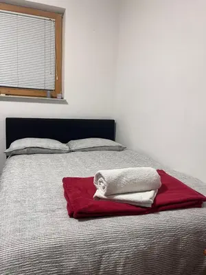 a bedroom with a bed with two towels on it at Urko Apartments Ljubljana in Ljubljana
