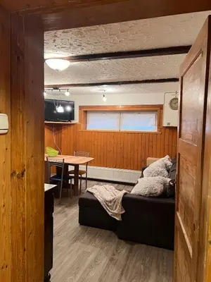 a room with a bed and a table in it at Cosy apartment in Ljubljana in Šentvid