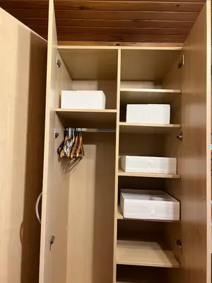 a closet with white shelves and boxes in it at Cosy apartment in Ljubljana in Šentvid