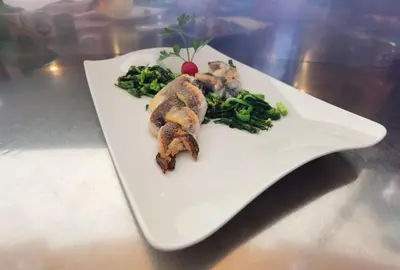 a white plate with food on a table at Guest house 902 Črnivec in Gornji Grad
