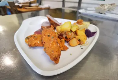 a plate of food with fish and vegetables on a table at Guest house 902 Črnivec in Gornji Grad