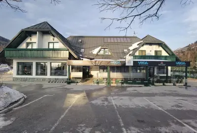 a parking lot in front of a building at Guest house 902 Črnivec in Gornji Grad