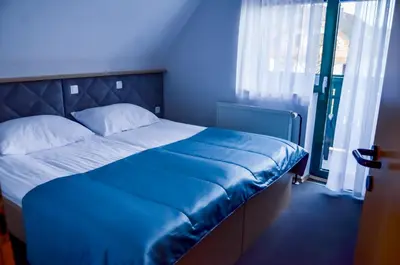 a blue bedroom with a large bed with blue sheets at Guest house 902 Črnivec in Gornji Grad
