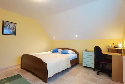 a bedroom with a bed and a desk at Guest house 902 Črnivec in Gornji Grad