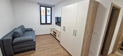 a living room with a couch and a cabinet at Apartmaji Siliganum in Solkan