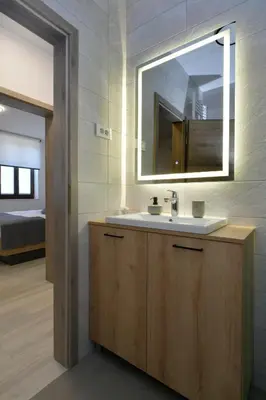 a bathroom with a sink and a mirror at Apartmaji Siliganum in Solkan
