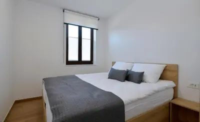 a bedroom with a large bed with two pillows at Apartmaji Siliganum in Solkan