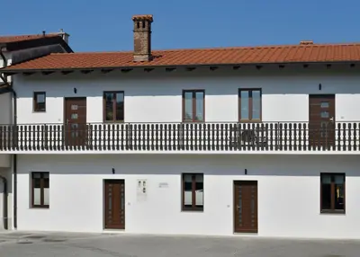 a white building with a balcony at Apartmaji Siliganum in Solkan