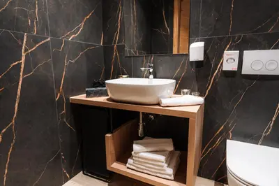 a bathroom with a sink and a counter with towels at Apartmaji Vouk - sodobni apartmaji v objemu narave - Lukanja - Rogla - Primerno za pare in družine - Sprostitev in aktivno preživljanje prostega časa in Oplotnica