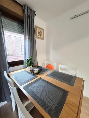 a dining room with a wooden table with chairs at Terme Banovci - Pomurski raj, tickets included in Veržej